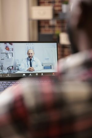 Young adult talking to doctor on videocall